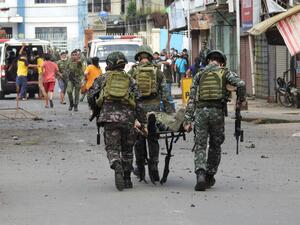 Soldiers stretcher away a comrade after an improvised bomb exploded next to a military vehicle in the town of Jolo on Sulu island on August 24, 2020. Nickee BUTLANGAN / AFP