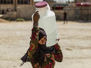 A displaced Syrian brings water back to their camp in a camp for the displaced in Syria's northeastern city of Hasakah on August 24, 2020. Delil SOULEIMAN / AFP