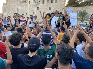 Libyans chant slogans during a demonstration due to poor public services at the Martyrs' Square at the centre of the GNA-held Libyan capital Tripoli on August 24, 2020. AFP