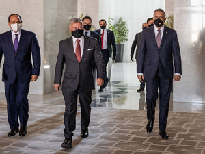 Jordanian King Abdullah, center, arrives with Egyptian President Abdel Fattah El-Sisi, left, and Iraqi Prime Minister Mustafa Al-Kadhimi at the summit in Amman. (AFP)