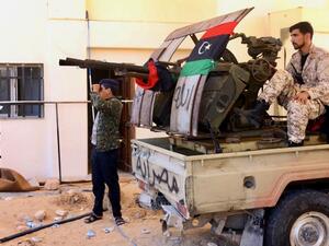 Libyan fighters loyal to GNA hold position near Salah al-Din military compound south of capital Tripoli earlier this month (AFP)