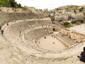 View from the top of the Roman Theatre, with tourists visiting and wandering around the roman ruins of Amman  (Shutterstock)	
