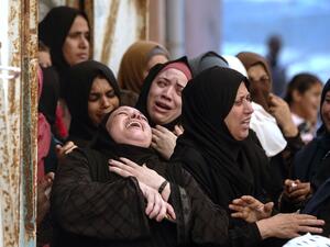 Palestinian women mourn during the funeral of three children who were killed in a fire ignited by a candle used to light up their room during a power cut in al-Nusirat refugee camp in the central Gaza Strip on September 2, 2020.MAHMUD HAMS / AFP
