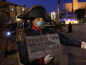 A face mask is painted on a statue of French emperor Napoleon Bonaparte in the Israeli coastal city of Jaffa, south of Tel Aviv, on September 2, 2020, during the novel coronavirus crisis. Emmanuel DUNAND / AFP
