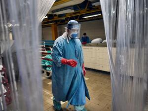 A worker walks at the laundry room of the Mexican Institute of Social Security (IMSS), in Mexico City on September 10, 2020 amid the COVID-19 coronavirus pandemic. Cleaning workers also risk their lives in Mexico's pandemic hospitals, knowing that their efforts often go unnoticed. ALFREDO ESTRELLA / AFP