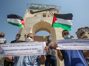 Palestinians carry placards during a protest in Rafah in the southern Gaza Strip, on September 12, 2020, to condemn the normalisation of ties between Israeli and Bahrain. The Palestinian cause has long cemented ties between Middle East nations with divergent interests, but amid shifting regional alliances they are increasingly isolated and in need of new friends, analysts say. In the latest blow, Bahrain broke ranks and agreed on Friday to open diplomatic ties with Israel, in a deal announced in Washington 
