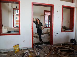 Lebanese entrepreneur Gizelle Hassoun stands amidst the rubble of the Madame Om pub, in the Lebanese capital's Gemmayze area on September 18, 2020. Nestled on the first floor of a blue villa in Beirut's lively Gemmayzeh district, Madame Om was once a popular night spot famed for its weekend parties and drag shows. But today the walls of the rented venue are cracked, part of its floor has caved in, and its balcony has been blown off. The pub is going to have to move. ANWAR AMRO / AFP