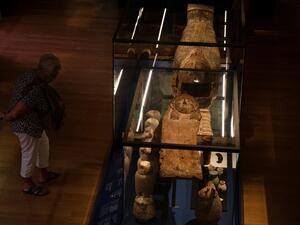 Visitors looks at a sarcophagus with a mummy inside during the exhibition "Pharaon, Osiris and mummy" at the museum Granet in Aix-en-Provence, southeastern France, on September 18, 2020. The exhibition will take place from September 19 until February 14 2021. Christophe SIMON / AFP