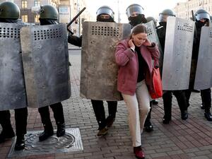 A woman hustles with law enforcement officers as they block the road during a demonstration called by opposition movement for an end to the regime of authoritarian leader in Minsk on September 20, 2020. Belarus President Alexander Lukashenko, who has ruled the ex-Soviet state for 26 years, claimed to have defeated opposition leader Svetlana Tikhanovskaya with 80 percent of the vote in the August 9, elections. AFP