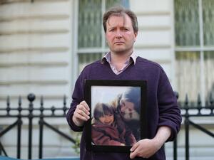 Richard Ratcliffe, husband of Nazanin Zaghari-Ratcliffe, a British-Iranian woman is in prison in Iran, with a photograph of his wife and daughter outside the Iranian Embassy in London this week. (Isabel Infantes / AFP - Getty Images)