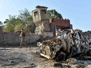 Security personnel inspect the site of a car bomb attack that targeted a government building in Ghani Khel district of Nangarhar province on October 3, 2020. At least 15 people were killed and more than 30 others wounded in a car bomb attack that targeted a government building in eastern Afghanistan on October 3, officials said.  NOORULLAH SHIRZADA / AFP
