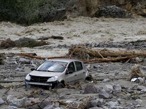 A car lies in mud after being moved by the floods of the Vesubie river in Roquebilliere, southeastern France, on October 3, 2020. after heavy rains and floodings hit the Alpes-Maritimes department. Heavy rains and brutal floods have left villages cut off from the world in the Alpes Maritimes, where hundreds of fire-fighters have been mobilised on October 3, to find nine missing persons. NICOLAS TUCAT / AFP