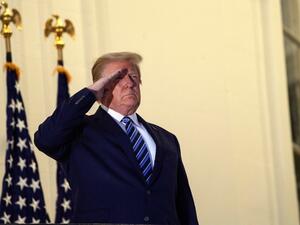  In this file photo US President Donald Trump salutes from the Truman Balcony upon his return to the White House from Walter Reed Medical Center, where he underwent treatment for Covid-19, in Washington, DC, on October 5, 2020. President Donald Trump doubled down on October 6, 2020 on the macho image his fans adore after declaring himself cured of Covid-19 and scoffing at disastrous opinion polls only four weeks before election day against Democrat Joe Biden."FEELING GREAT!" he tweeted, also insisting that 