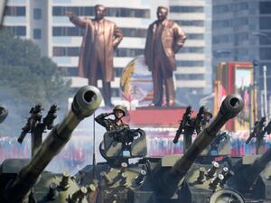 In a file photo taken on September 9, 2018 Korean People's Army (KPA) soldiers salute as they ride tanks during a military parade and mass rally on Kim Il Sung square in Pyongyang. All eyes will be on North Korea October 10, 2020 as it celebrates the 75th birthday of the ruling Workers' Party, with speculation mounting for a "big event" showcasing the nuclear-armed nation's military strength.  Ed JONES / AFP