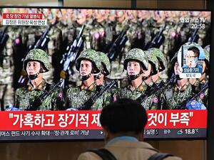 A man watches a television news broadcast of a military parade commemorating the 75th anniversary of North Korea's ruling Workers' Party held in Pyongyang, at a railway station in Seoul on October 10, 2020. Nuclear-armed North Korea held a giant military parade on October 10, television images showed, with thousands of maskless troops defying the coronavirus threat and Pyongyang expected to put on show its latest and most advanced weapons. Jung Yeon-je / AFP