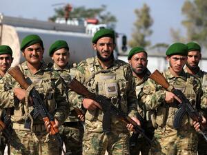 Turkey-backed Syrian fighters take part in a parade in the rebel-controlled town of Tal Abyad in Syria's northern Raqa province, on October 13, 2020. Bakr ALKASEM / AFP