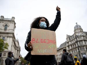 Protestors carry placards as they gather for a protest against police brutality in Nigeria, in Parliament Square in central London on October 24, 2020. (AFP/File Photo)