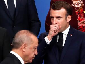 In this file photo taken on December 4, 2019 France's President Emmanuel Macron (R) gestures as Turkey's President Recep Tayyip Erdogan walks past him during a family photo as part of the NATO summit at the Grove hotel in Watford, northeast of London. Turkish President Recep Tayyip Erdogan slammed on October 24, 2020 his French counterpart, Emmanuel Macron, over his policies toward Muslims, saying that he needed "mental checks." "What can one say about a head of state who treats millions of members from dif