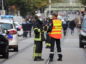 French policemen and firefighters stand guard a street after a knife attack in Nice on October 29, 2020. A man wielding a knife outside a church in the southern French city of Nice slit the throat of one person, leaving another dead and injured several others in an attack on Thursday morning, officials said. (AFP)