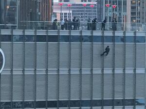 On Sunday a man was seen dangling from a rope outside the 16th floor of Trump Tower in downtown Chicago. (Twitter)