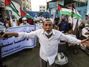 A Palestinian man reacts during a rally to protest against the reduction of the food basket provided by the United Nations Relief and Works Agency for Palestine Refugees in the Near East (UNRWA), in front of the agency's headquarters in the town of Khan Yunis in the Southern Gaza Strip, on October 18, 2020. SAID KHATIB / AFP