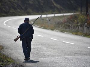 An elderly man walks along a road with a shotgun near the disputed Nagorno-Karabakh province's town of Shusha on October 31, 2020, amid the ongoing military conflict between Armenia and Azerbaijan over the breakaway region. Karen MINASYAN / AFP