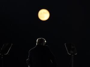 US President Donald Trump speaks as a full moon rises during a rally at Pittsburgh-Butler Regional Airport in Butler, Pennsylvania on October 31, 2020. MANDEL NGAN / AFP