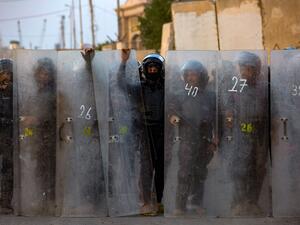 Iraqi riot police form a barier as demonstrators gather near the local administration building in the southern city of Basra on November 6, 2020, during an anti-government protest. Hussein FALEH / AFP