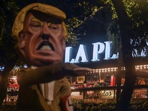 People look at a dummy depicting United States President Donald Trump making a Nazi salute from a restaurant during a protest against him in Medellin, Colombia, on November 6, 2020, in the framework of the US election. A US Supreme Court justice on Friday denied a request by Pennsylvania's Republicans to immediately halt the counting of ballots arriving after Election Day -- referring the challenge to the full court for a ruling on Saturday. JOAQUIN SARMIENTO / AFP