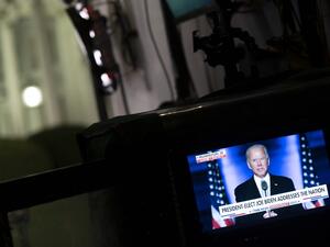 A screen shows US President-elect Joe Biden delivering remarks in Wilmington, on a monitor near the White House on November 7, 2020 in Washington, DC. Democrat Joe Biden urged unity on November 7 and promised "a new day for America" in his first national address since he won the tense US election and ended the historically turbulent and divisive era of Donald Trump. ANDREW CABALLERO-REYNOLDS / AFP