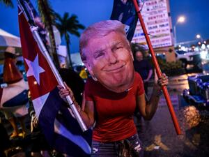 Trump supporters hold signs and flags during a protest in Miami on November 7, 2020, after Joe Biden was declared the winner of the presidential election.  CHANDAN KHANNA / AFP