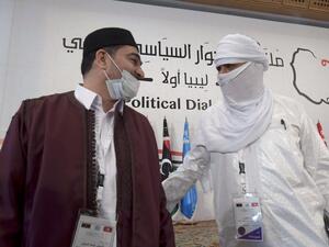 Libyan participants in the UN-led Libyan Political Dialogue Forum Abdallah Shibani (L) and Hussein Mohamed Elansari, greet each other at the opening of the talks in Gammarth on the outskirts of Tunisia's capital, on November 9, 2020. AFP