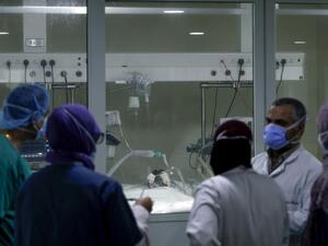 A medical team gathers in front of a COVID-19 patient's room in the intensive care unit of the Rafic Hariri University Hospital in the Lebanese capital Beirut, on November 13, 2020. JOSEPH EID / AFP