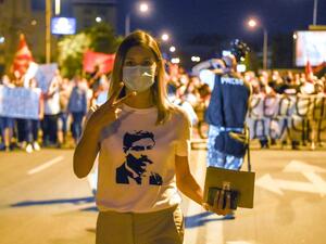 This photograph taken on September 15, 2020, shows a protestor wearing a T-shirt with an image of revolutionary figure Goce Delchev, gesturing as she takes part in an anti-government protest in Skopje. After changing its name last year to settle a decades-old battle with Greece, the small Balkan state of North Macedonia was finally on a path to join the European Union. Until Bulgaria stepped in. Robert ATANASOVSKI / AFP