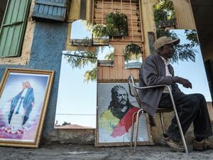 A man seats in front of a shop selling mirrors and paintings in Gondar, Ethiopia, on November 23, 2020. EDUARDO SOTERAS / AFP