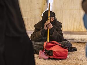 An elderly Syrian woman waits to leave the Kurdish-run al-Hol camp holding relatives of alleged Islamic State (IS) group fighters, in the al-Hasakeh governorate in northeastern Syria, on November 24, 2020. AFP