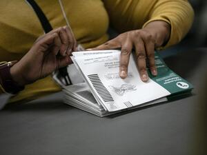 Election workers sort absentee ballots to count at the Lansing city clerk's office on election night on November 03, 2020 in Lansing, Michigan. President Trump narrowly won Michigan in 2016, and both he and Joe Biden campaigned heavily in the battleground state in 2020. John Moore/Getty Images/AFP JOHN MOORE / GETTY IMAGES NORTH AMERICA / Getty Images via AFP