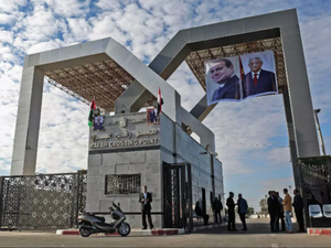 Portraits of Egyptian President Abdel Fattah al-Sisi and Palestinian leader Mahmud Abbas hang at the Rafah border crossing with Egypt. (Said Khatib, AFP )