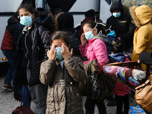 Migrants wait to be transferred to the port of Mytilene from the village of Skala Sikamias, on the island of Lesbos, Greece, March 4, 2020.  (Shutterstock)	
