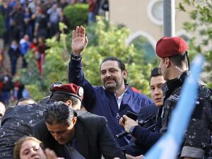 Lebanese prime minister Saad Hariri greets his supporters upon his arrival at his home in Beirut on November 22, 2017. Marwan Tahtah / AFP