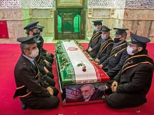 Members of Iranian forces pray around the coffin of slain nuclear scientist Mohsen Fakhrizadeh during the burial ceremony at Imamzadeh Saleh shrine in northern Tehran, on November 30, 2020.HAMED MALEKPOUR / TASNIM NEWS / AFP