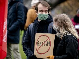 A couple holds a placard during a demonstration against racism at the Koekamp park in The Hague, The Netherlands on December 6 2020. Human rights and climate organisations staged the protest after a series of discriminatory actions, including the defacement of The Black Archives premises. Sander Koning / ANP / AFP