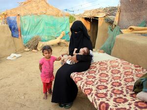A woman carries a young infant suffering from severe malnutrition since birth in Yemen's northern Hajjah province on December 6, 2020. ESSA AHMED / AFP