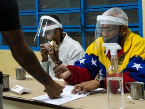 Venezuelans voted Sunday in legislative elections set to tighten President Nicolas Maduro's grip on power and further weaken his US-backed opposition rival Juan Guaido, who is leading a boycott of the polls he calls a fraud. Cristian Hernandez / AFP