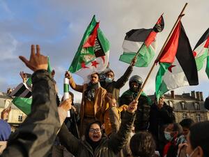 Supporters of Western Sahara's independence hold Western Sahara and Algerian flags during a demonstration, in Bordeaux, southwestern France on December 12, 2020. Algeria, Morocco's neighbour and regional rival, is the key foreign backer of the Polisario Front, which has campaigned for independence for Western Sahara since the 1970s. thibaud MORITZ / AFP