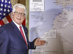David T. Fischer, US Ambassador to the Kingdom of Morocco, standing before a US State Department-authorised map of Morocco recognising the internationally-disputed territory of the Western Sahara (bearing a signature by Fischer) as a part of the North African kingdom, in Morocco's capital Rabat on December 12, 2020. AFP