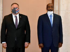 In this file photo taken on August 25, 2020, US Secretary of State Mike Pompeo (L) poses for a picture with Sudan's Sovereign Council chief General Abdel Fattah al-Burhan in Khartoum. The United States on December 14, 2020 formally removed Sudan's state sponsor of terrorism designation, 27 years after putting the country on its blacklist, the US embassy in Khartoum announced. "The congressional notification period of 45 days has lapsed and the Secretary of State has signed a notification stating rescission 