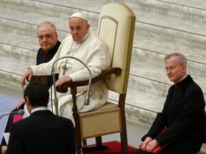 Pope Francis, flanked by Monsignor Leonardo Sapienza (L) and Monsignor Luis Maria Rodrigo Ewart (R), attends an audience to deliver his Christmas greetings to the employees of the Vatican, on December 21, 2020 at Paul-VI hall at The Vatican. Vincenzo PINTO / AFP