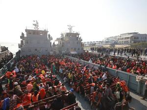 Rohingya refugees sit on a Bangladesh Navy ship as they are relocated to the controversial flood-prone island Bhashan Char in the Bay of Bengal, in Chittagong on December 29, 2020. Rehman ASAD / AFP