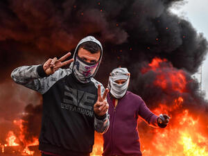 Masked protesters during an anti-government demonstration in Habboubi square in the centre of Iraq’s southern city of Nasiriyah in Dhi Qar province on November 29, 2020. (AFP),